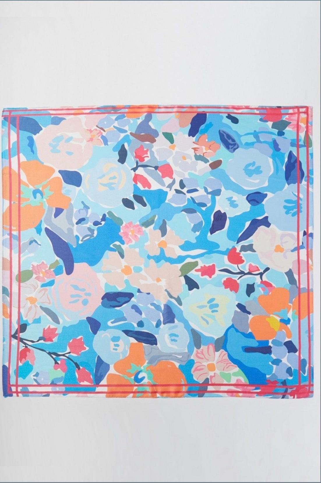 Square blue floral bandana scarf featuring an abstract garden print in shades of blue, coral, pink, ivory, and navy with a contrasting pink border.