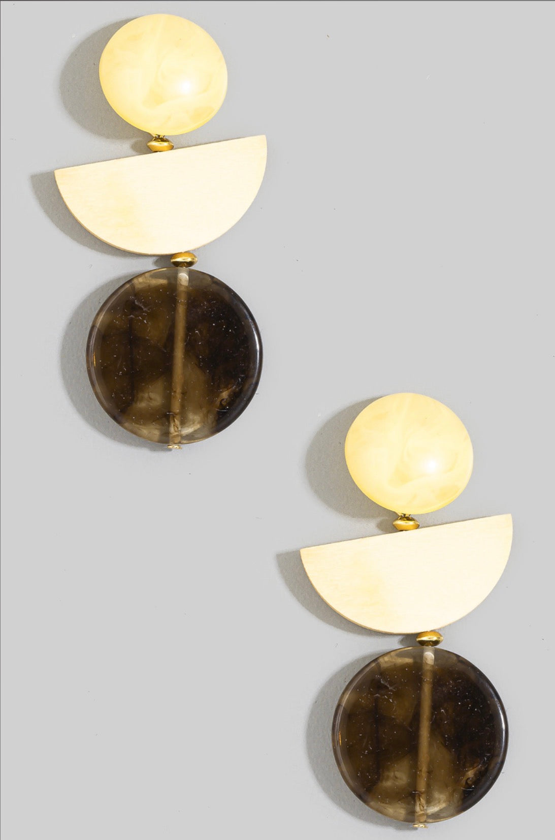Brown geometric drop earrings featuring an ivory marbled stud, cream half-moon accent, and translucent smoky brown resin disc.