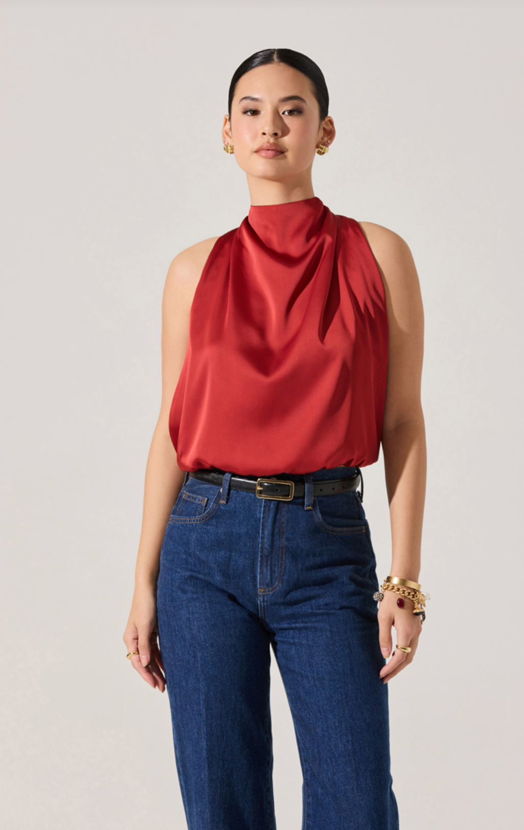 Model wearing the Joleisa Top in red with high neckline, bubble hem, and bow tie back