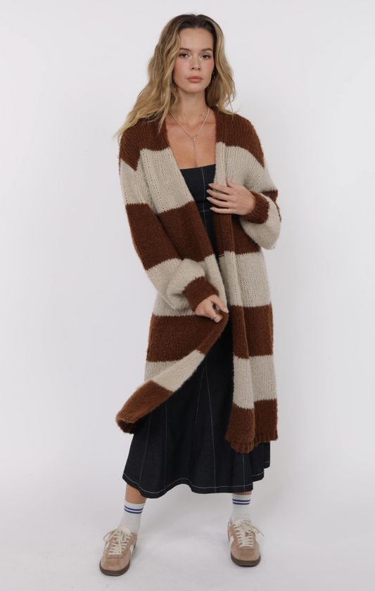Model wearing long striped duster cardigan with bubble sleeves in brown and cream