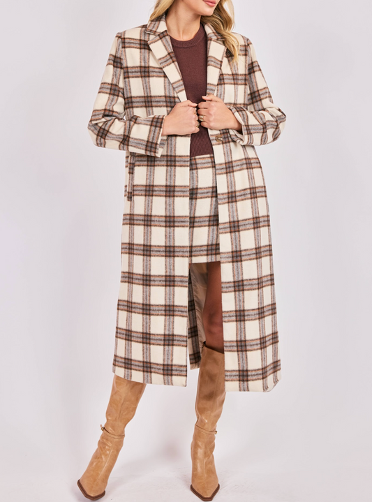 Woman wearing a cream and brown plaid long wool-blend coat with tan knee-high boots.