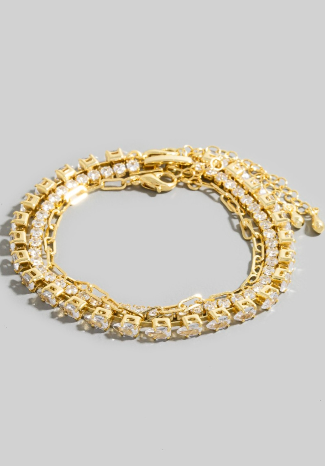 Gold-dipped layered bracelet with CZ tennis rows and chain accents