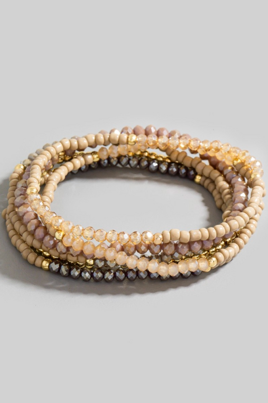 Neutral faceted and metallic beaded bracelet set with gold and taupe tones stacked together