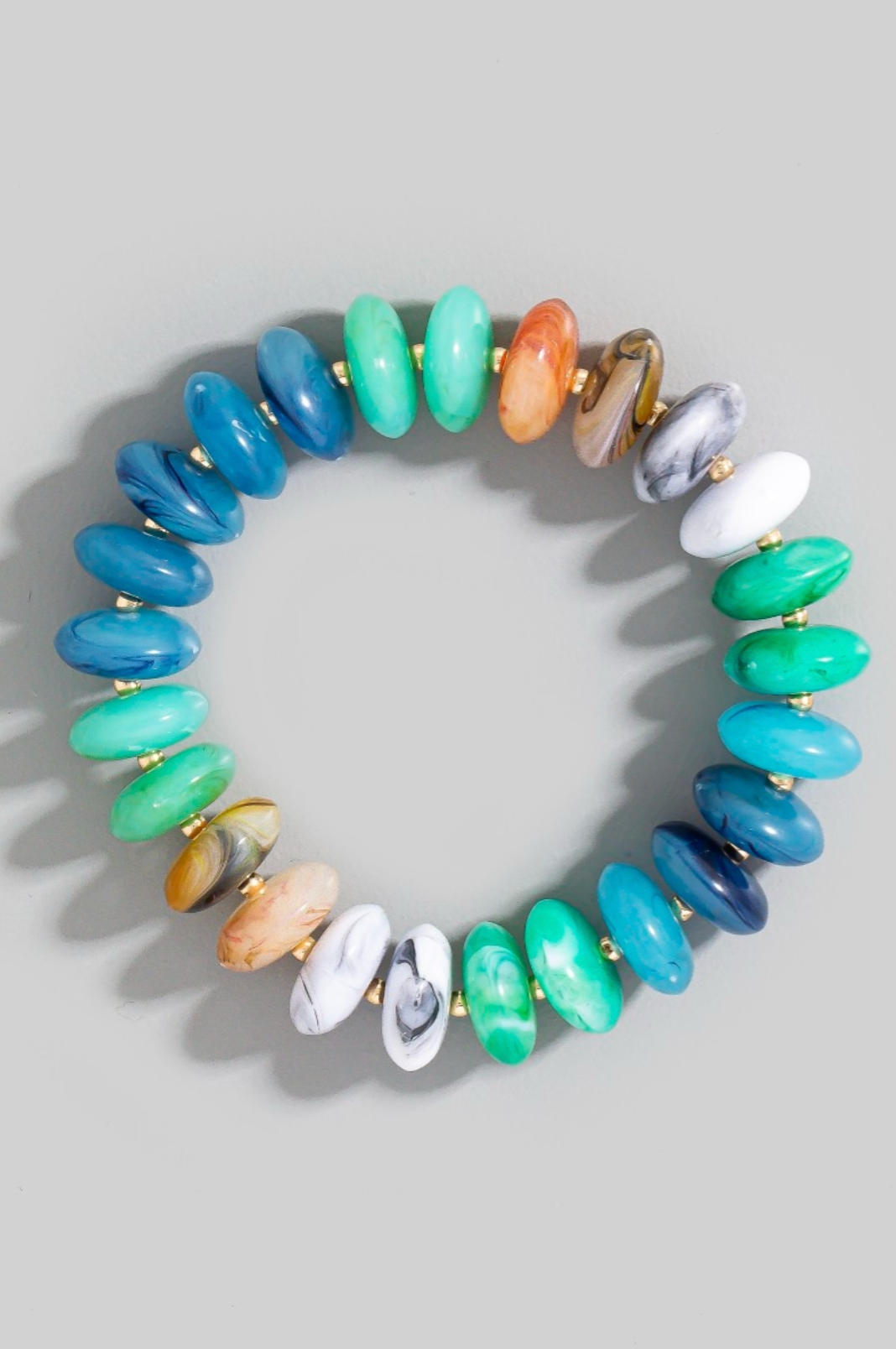 Multicolored beaded bracelet on a light gray background