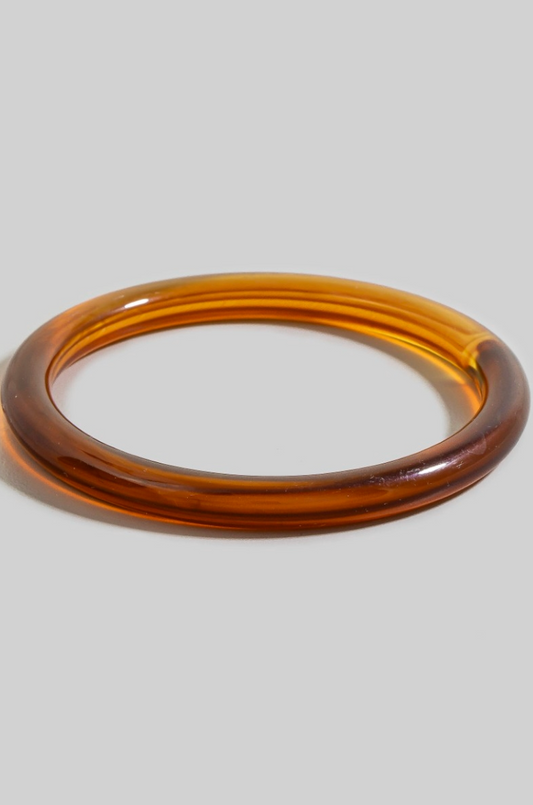 Rhea Resin Bangle Bracelet in warm caramel resin with glossy tubular finish