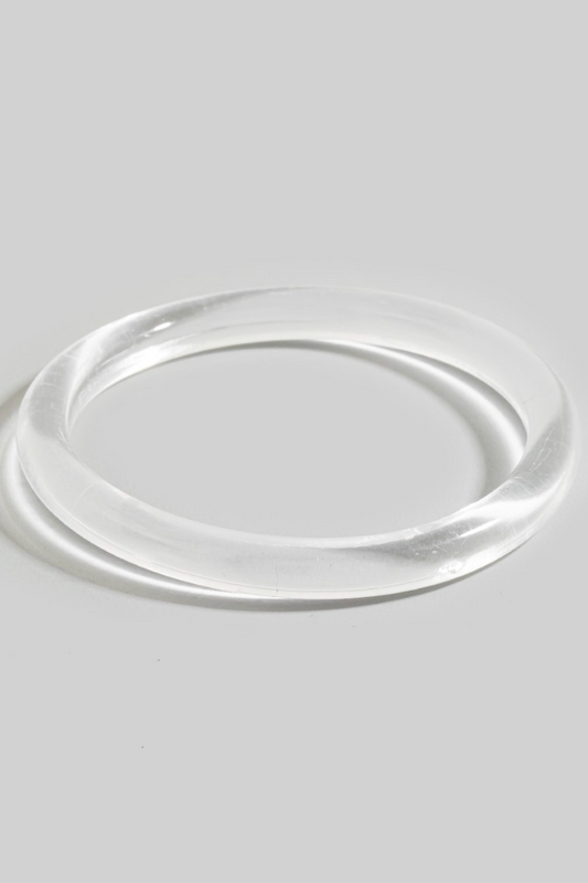 Rhea Resin Bangle Bracelet in clear resin with sleek tubular silhouette