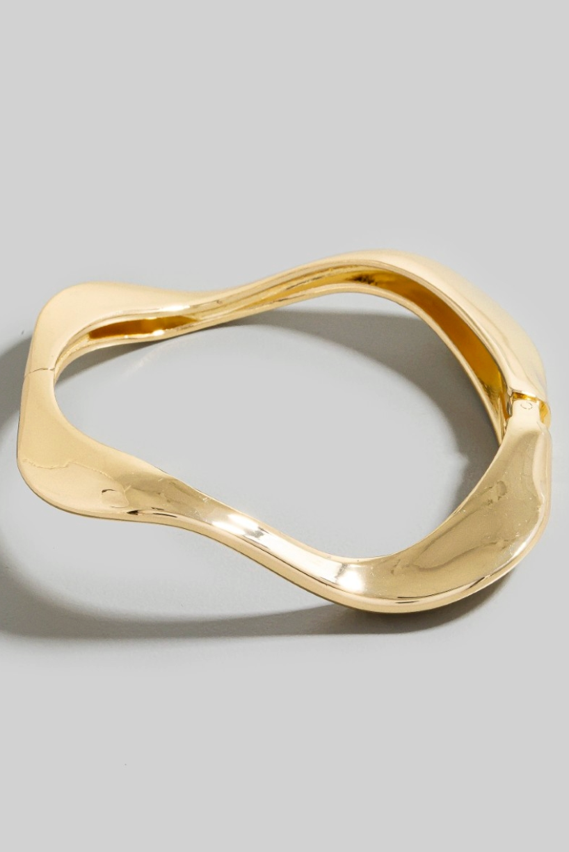Mira Wave Metal Bangle in polished gold sculptural design