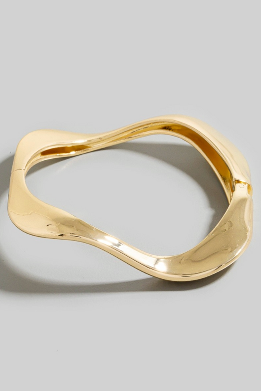Mira Wave Metal Bangle in polished gold sculptural design