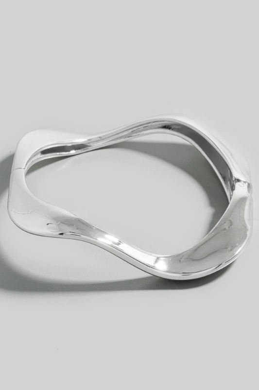 Mira Wave Metal Bangle in polished silver sculptural design