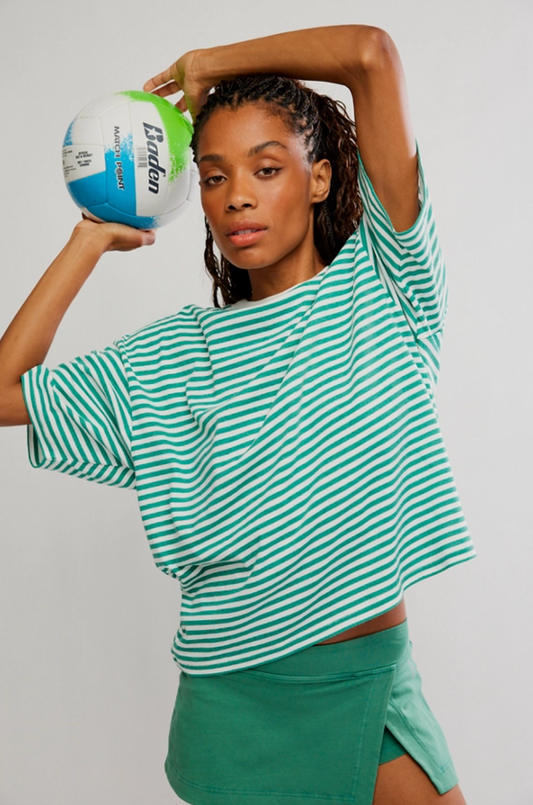 Model wearing green and white striped Stripe Tackle Tee with relaxed boxy fit and ribbed crew neckline