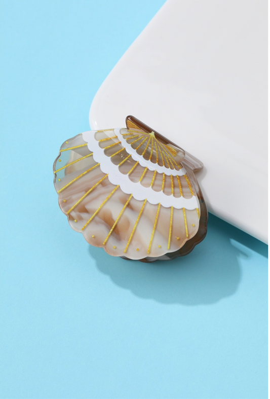 Brown marbled seashell-shaped acetate hair claw clip with gold ridged detailing
