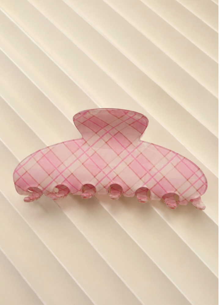 Kelsey Plaid Claw Clip Coral featuring a rounded coral plaid hair claw with interlocking teeth.