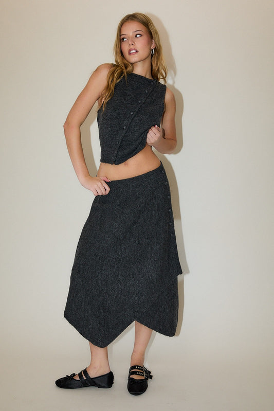 Woman wearing Shadow Muse Sweater Set with boat-neck top and asymmetrical midi skirt in charcoal grey