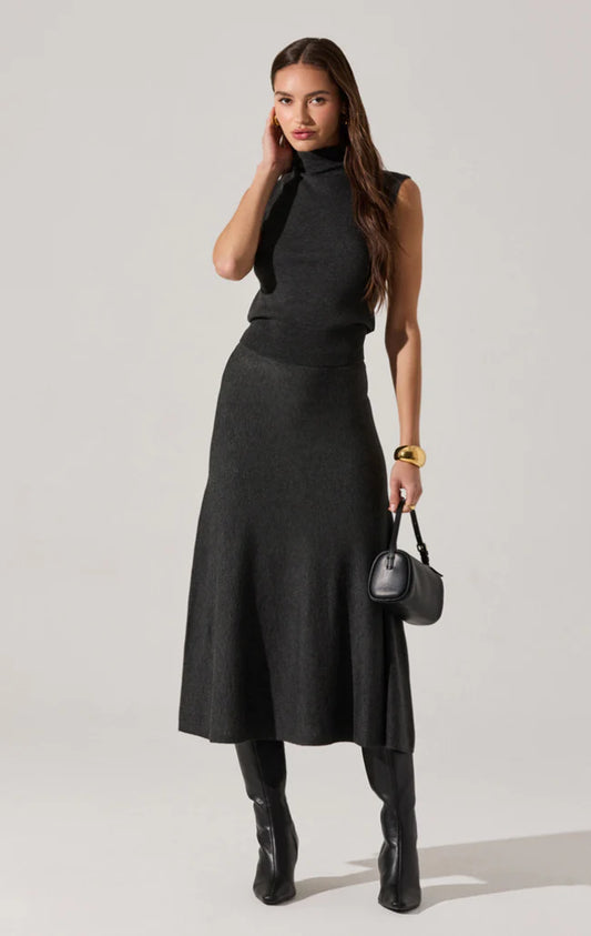 Model wearing the Deora Midi Sweater Skirt, a flared knit midi with elastic waistband.