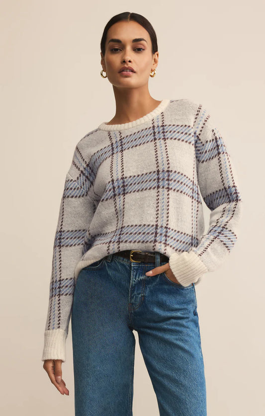 Woman wearing natural plaid crewneck sweater with blue and brown check pattern