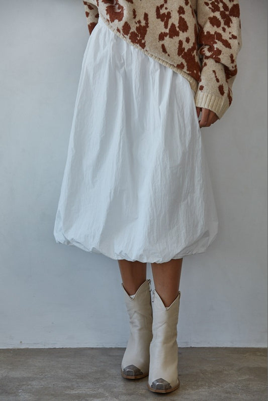 Woman wearing the Sundays Bubble Midi Skirt in crisp white nylon with bubble hem and A-line silhouette.
