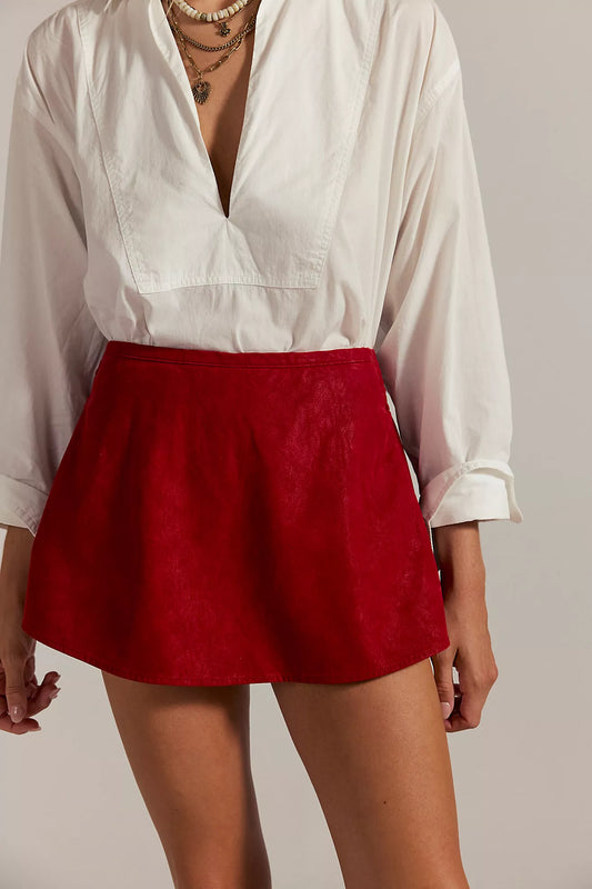 Vegan suede red mini skort with mid-rise fit, side pockets, and shorts lining