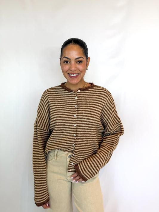 Model wearing a brown striped button-front cardigan with a relaxed fit