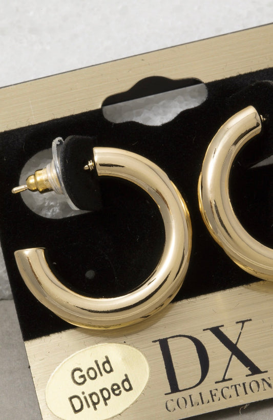 Gold-dipped thick tube hoop earrings with a polished mirror finish on display card, featuring oversized brass hoops for everyday and dressy styling.