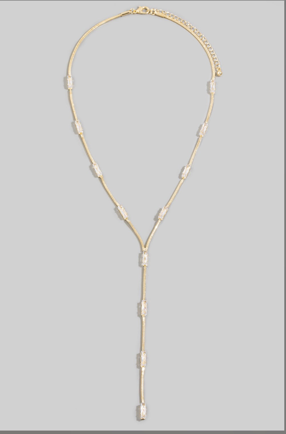 Gold-tone baguette cubic zirconia Y necklace featuring a sleek snake chain and elegant lariat drop, perfect for bridal, evening, and special occasion styling.