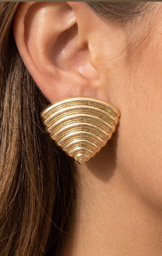 Gold fan-shaped ribbed statement stud earrings with a sculptural layered design and polished finish.