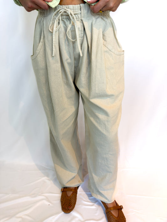 Light-colored pants with drawstring waist on a white background