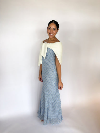 Woman wearing a blue and white dress against a white background