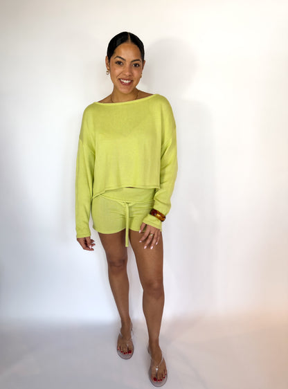 Woman wearing a bright green outfit on a white background