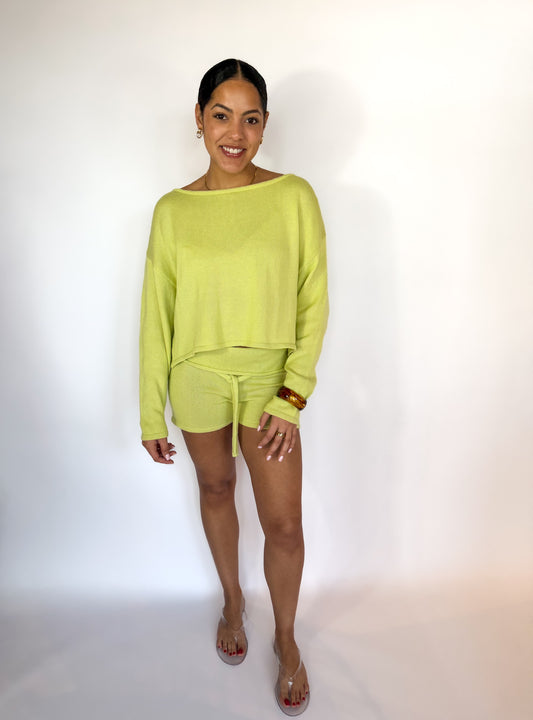Woman wearing a bright green outfit on a white background