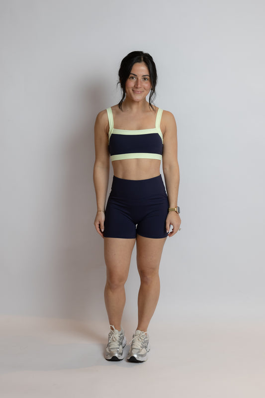 Woman wearing a sports outfit with a plain background