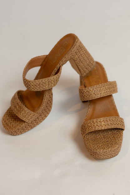 Pair of brown cork sandals on a light background