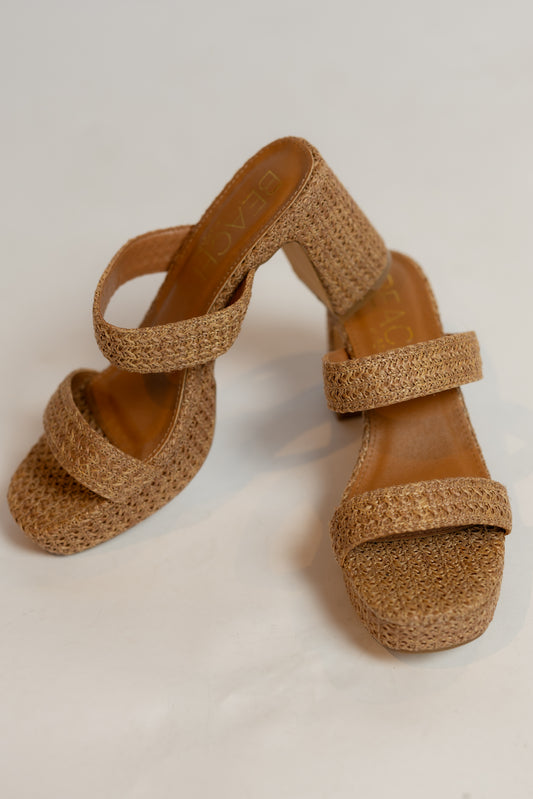 Pair of brown cork sandals on a light background