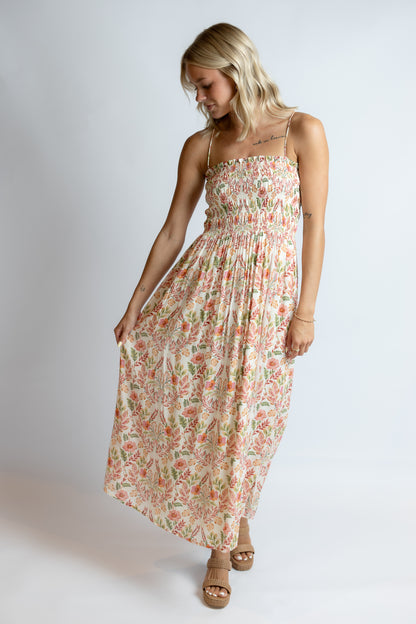 Woman wearing a floral dress on a plain background