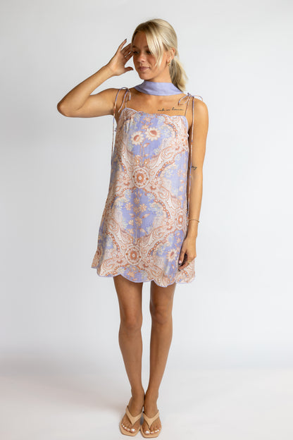 Woman wearing a floral dress against a white background