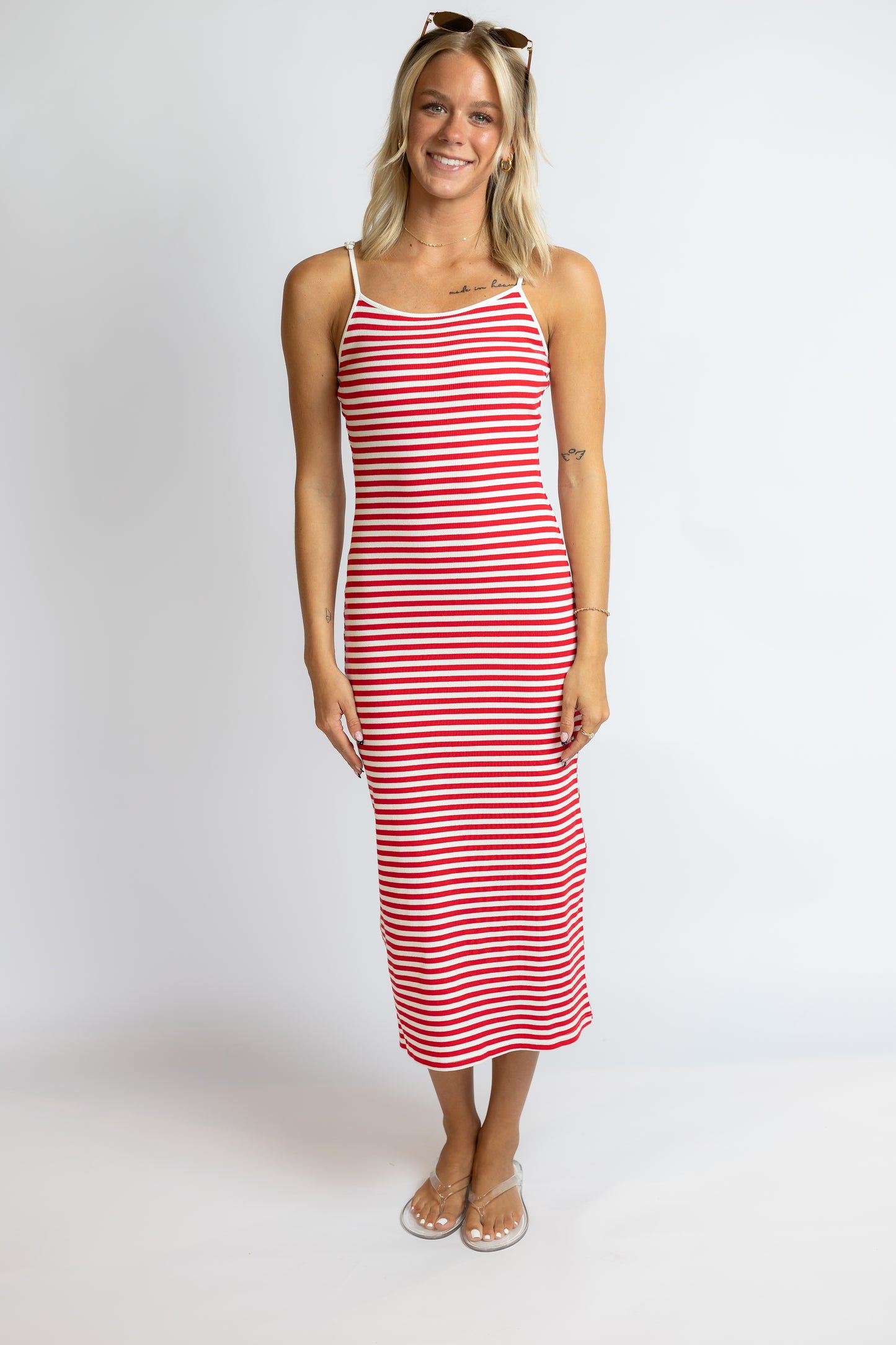 Woman wearing a red and white striped dress on a white background