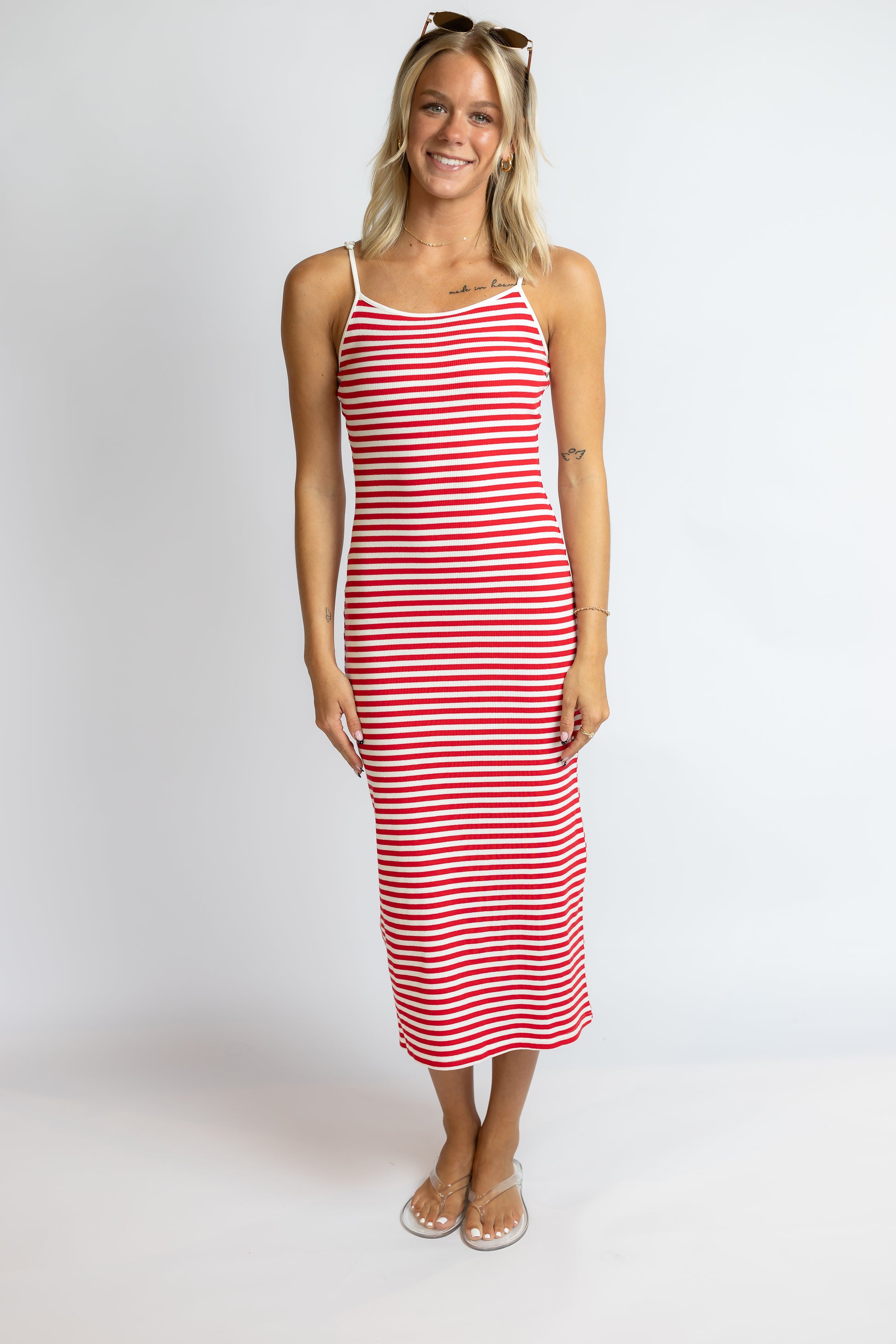 Woman wearing a red and white striped dress on a white background