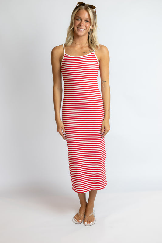 Woman wearing a red and white striped dress on a white background