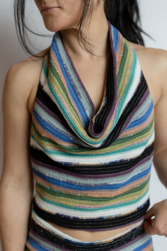 Multicolored striped sleeveless top worn by a person against a neutral background