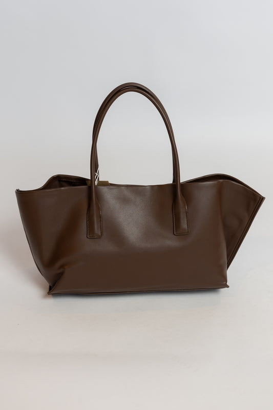 Brown leather tote bag on a light gray background