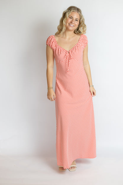 Woman wearing a red and white checkered dress on a white background