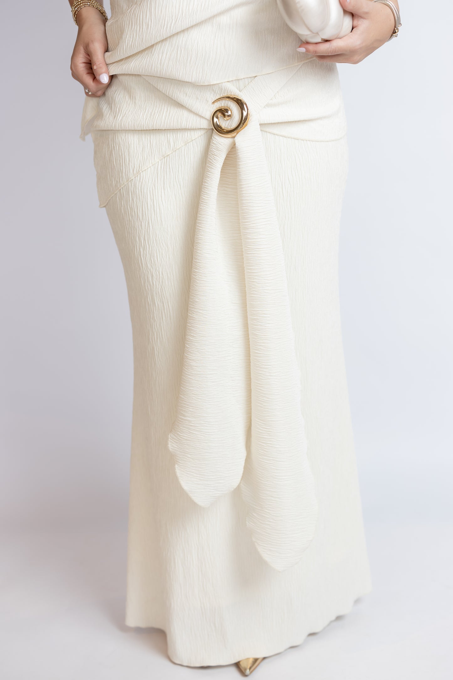 White skirt with a gold belt on a white background