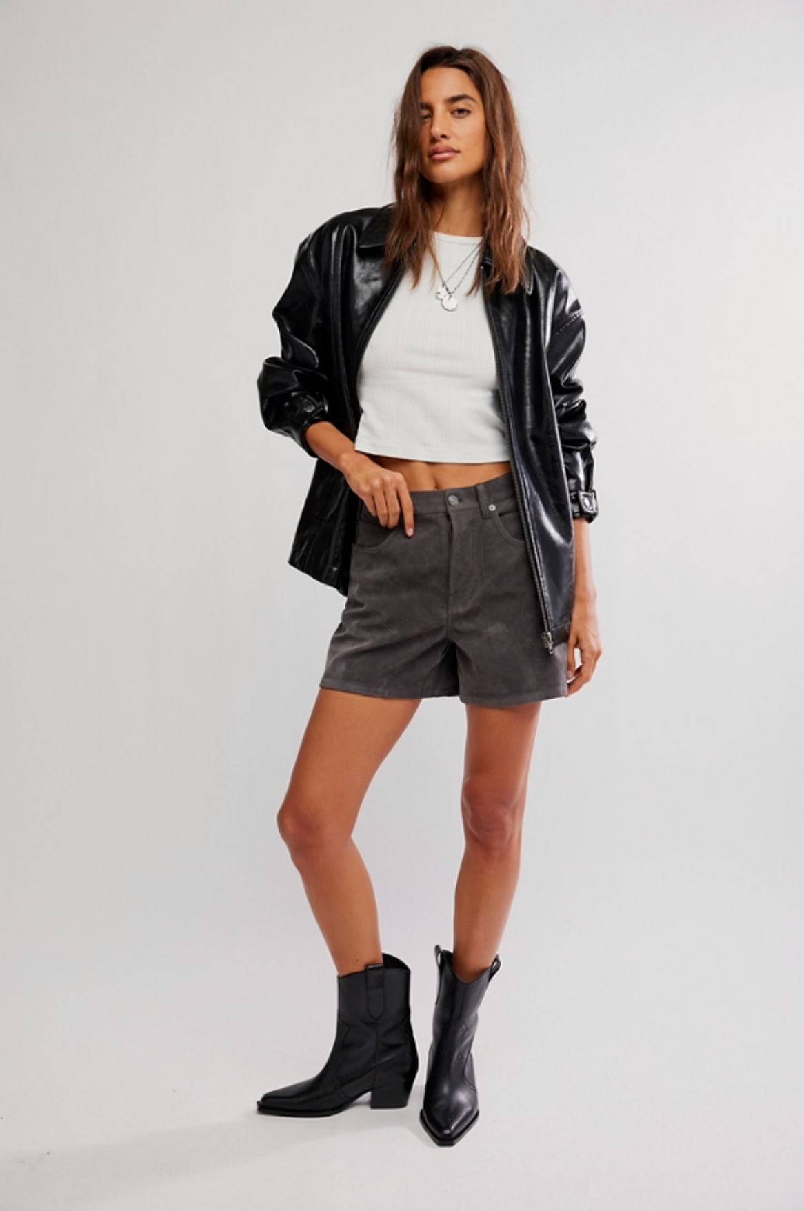 Woman wearing high-rise tan vegan suede shorts with five-pocket design and relaxed fit