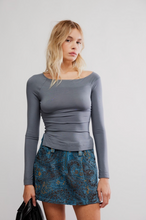 Load image into Gallery viewer, Woman wearing slate gray fitted wide-neck long sleeve top with blue jacquard mini skirt