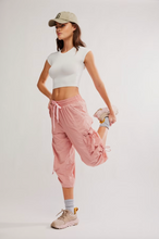Load image into Gallery viewer, Model wearing the Never Better Ultra-Light Tee in white, styled with pink jogger pants and sneakers.