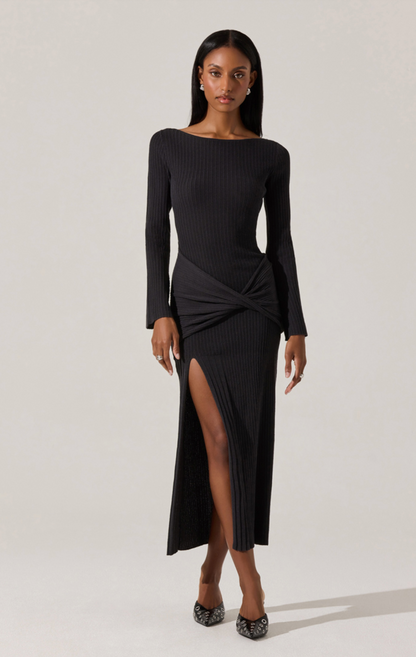 Model wearing the Arywn Wrap Detail Long Sleeve Sweater Dress in black with wrap waist detail, boatneck, and side slit