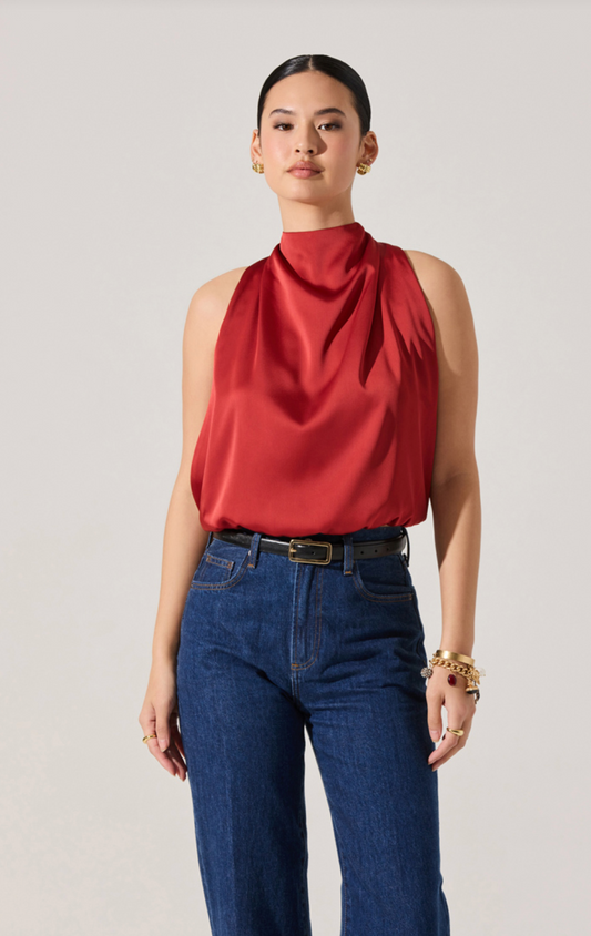 Model wearing the Joleisa Top in red with high neckline, bubble hem, and bow tie back