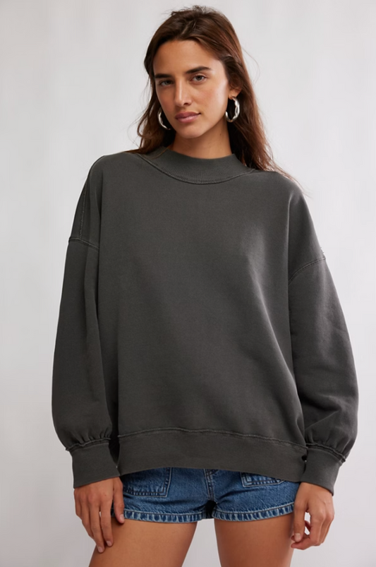 Oversized cotton pullover sweatshirt with mock neckline, exposed seams, and drop-shoulder sleeves