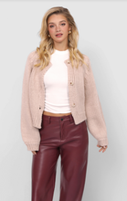 Load image into Gallery viewer, Model wearing blush chunky knit cropped button cardigan styled with white tee and burgundy leather pants