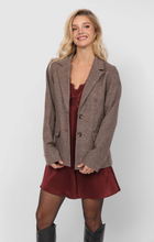 Load image into Gallery viewer, Model wearing brown houndstooth plaid double-button blazer layered over burgundy slip dress