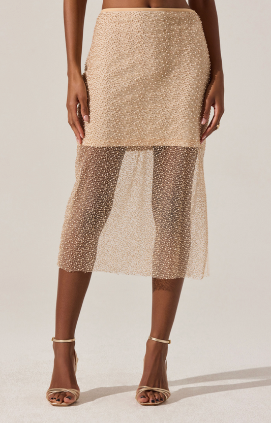 Model wearing the Messina Skirt, a shimmering beaded mesh midi skirt with sheer hem and side slit.